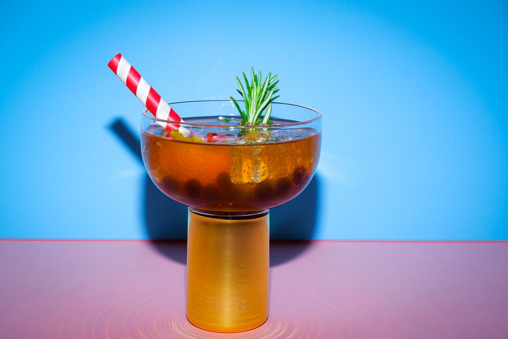 BOBABAM's Vanilla Grapefruit Champaign Spritz Bubble Tea with straw and rosemary garnish