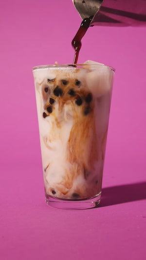 BOBABAM Brown Sugar Instant Boba Drink Kit being slowly poured into a glass of milk
